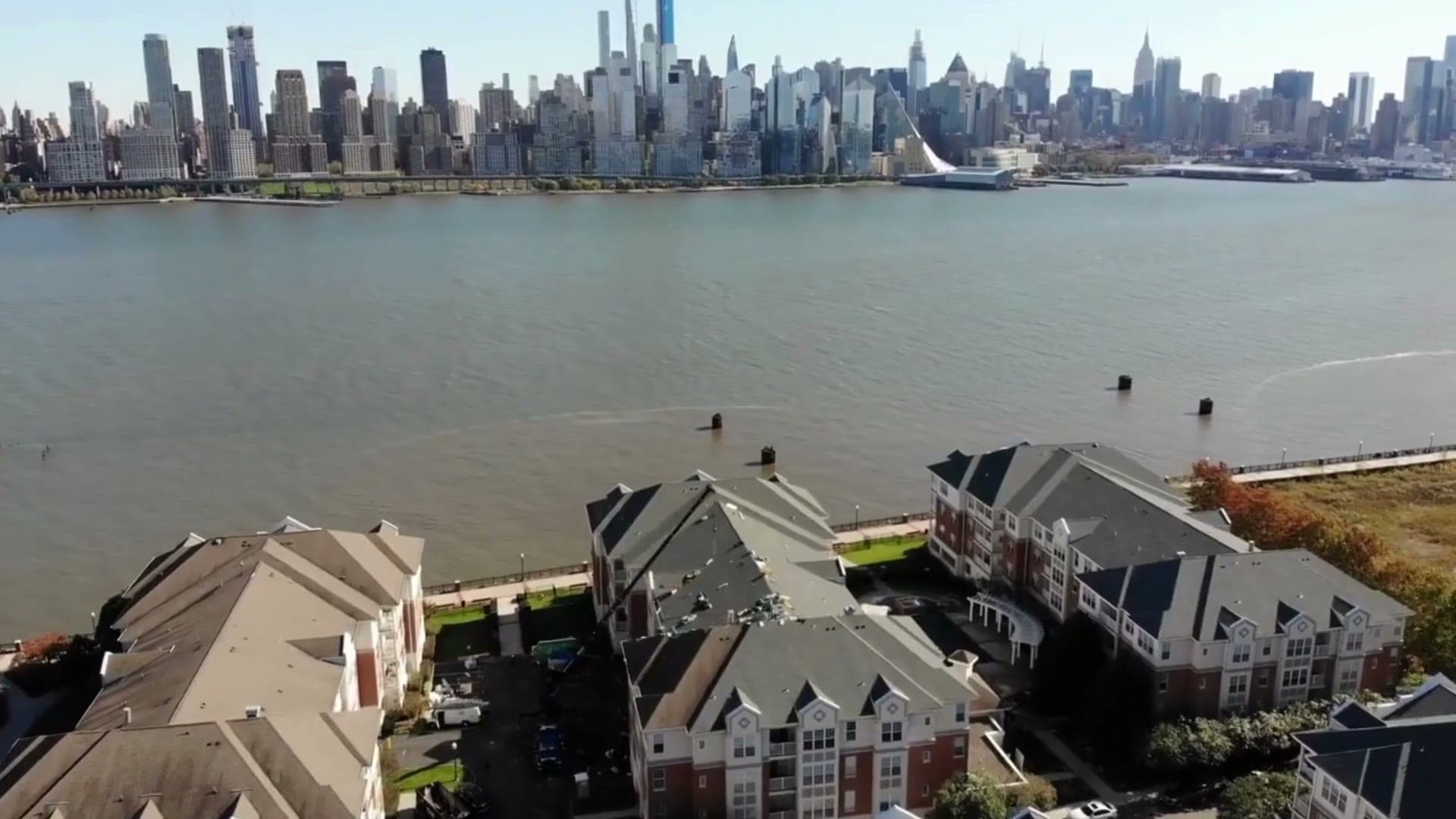 Multifamily re-roof along the Hudson River with the Manhattan skyline beyond